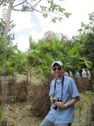 David in front of palm trees at Orchid World Barbados.jpg
