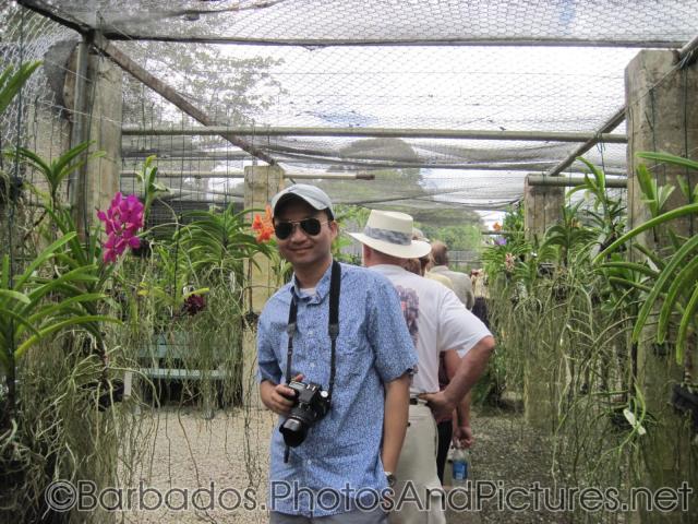 David next to purple orchid at Orchid World in Barbados.jpg
