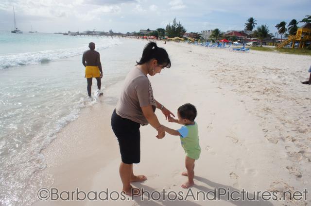 Darwin wants to hold mommy's hands while standing in the sands of Carlisle Bay Beach in Bridgetown Barbados.jpg
