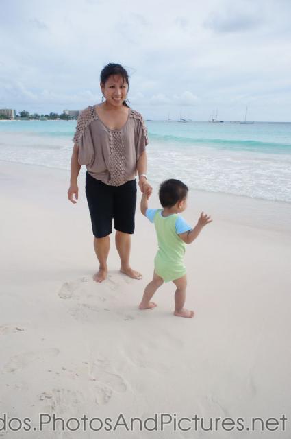 Darwin holds mommy's hand as he walks on the Carlisle Bay Beach in Bridgetown Barbados.jpg

