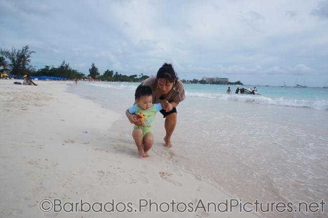 Darwin puts feet in the sands with help of mommy at Carlisle Bay Beach in Bridgetown Barbados.jpg
