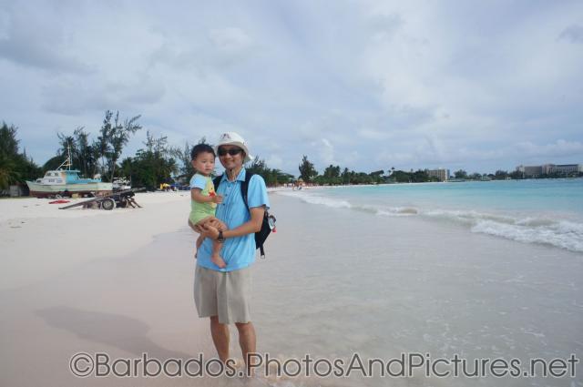 Darwin being held by daddy at Carlisle Bay Beach in Bridgetown Barbados.jpg
