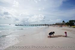 Kids playing in the sand at Carlisle Bay Beach in Bridgetown Barbados.jpg