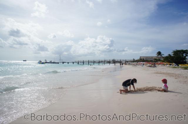 Kids playing in the sand at Carlisle Bay Beach in Bridgetown Barbados.jpg