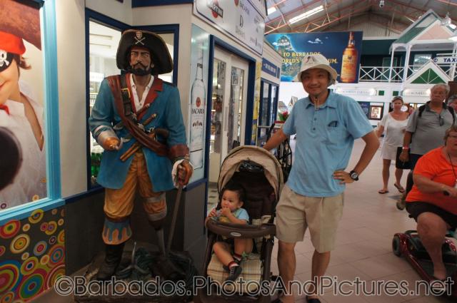 Darwin and daddy next to a pirate statue at Cruise Port Terminal in Bridgetown Barbados.jpg
