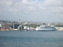 Older cruise ship docked next to factory in Barbados.jpg