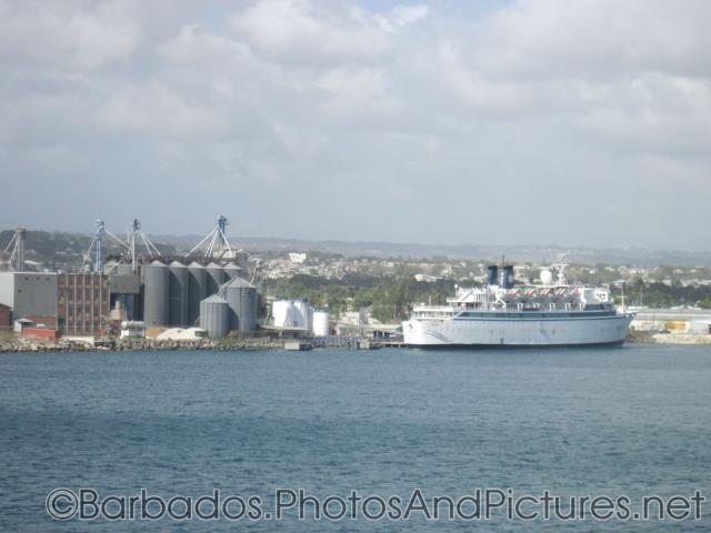 Older cruise ship docked next to factory in Barbados.jpg