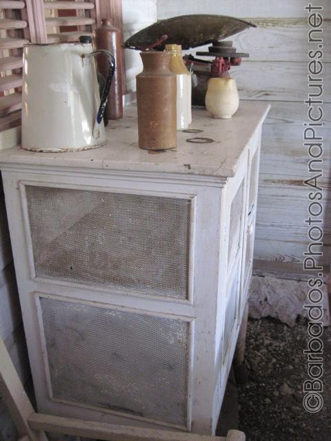 Cabinet with drinkware on top inside a cottage of Tyrol Cot in Barbados.jpg
