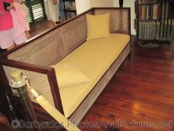 Sofa with yellow cushion at Tyrol Cot in Barbados.jpg